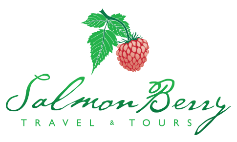 A salmon berry with three leaving hanging above the name of the company with Salmon Berry written in a fancy script and Travel & Tours written in an all caps, thin sans serif font underneath.